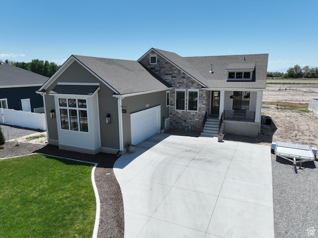 4817 W 50 S, West Point, UT 84015 - view of front of house with covered porch, a garage, roof with shingles, and stone siding