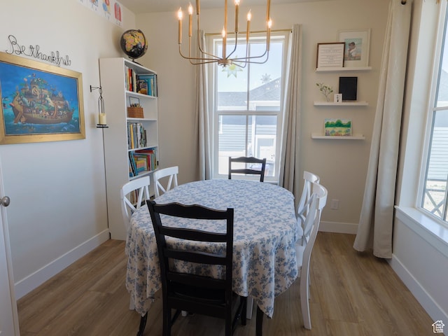 4817 W 50 S, West Point, UT 84015 - dining area with a chandelier, wood finished floors, and baseboards