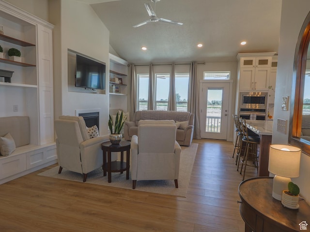 4817 W 50 S, West Point, UT 84015 - living area featuring a fireplace, light wood-type flooring, a ceiling fan, vaulted ceiling, and recessed lighting