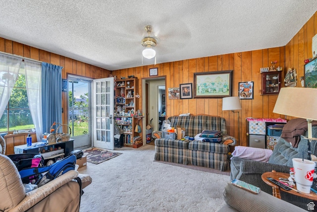 831 E Hillcrest Dr, Springville, UT 84663 - living room with carpet, ceiling fan, wooden walls, and a textured ceiling
