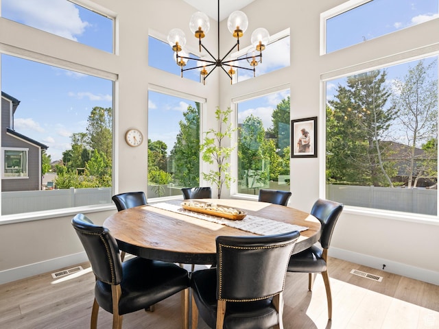 2393 N 300 E Unit 108, Lehi, UT 84043 - dining room with a chandelier, baseboards, wood finished floors, and a high ceiling