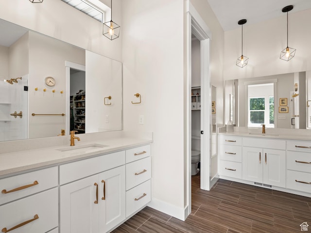 2393 N 300 E Unit 108, Lehi, UT 84043 - bathroom featuring a spacious closet, vanity, wood finish floors, toilet, and baseboards
