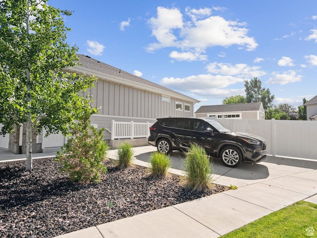 2393 N 300 E Unit 108, Lehi, UT 84043 - view of side of property featuring board and batten siding, concrete driveway, roof with shingles, and a garage