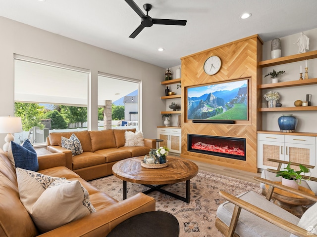 2393 N 300 E Unit 108, Lehi, UT 84043 - living area with a ceiling fan, a glass covered fireplace, wood finished floors, built in features, and recessed lighting