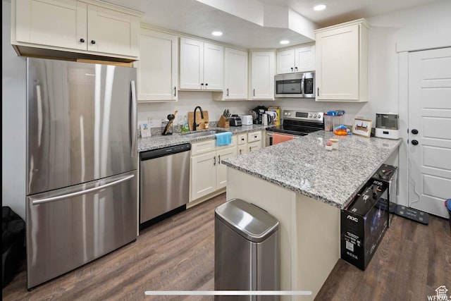 2393 N 300 E Unit 108, Lehi, UT 84043 - kitchen with appliances with stainless steel finishes, a sink, a peninsula, dark wood finished floors, and recessed lighting