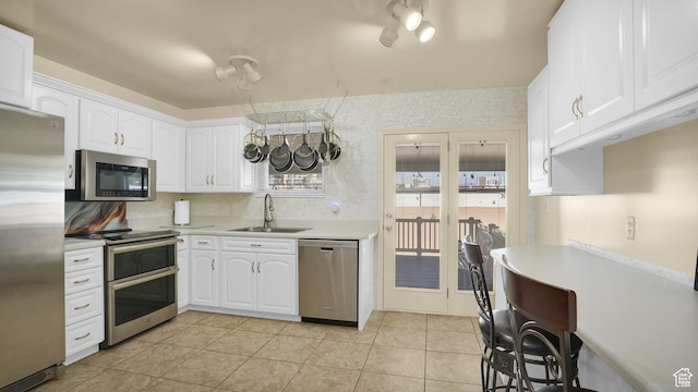9162 S Pebble Glen Cir, Sandy, UT 84094 - kitchen featuring stainless steel appliances, a sink, light countertops, white cabinetry, and light tile patterned flooring