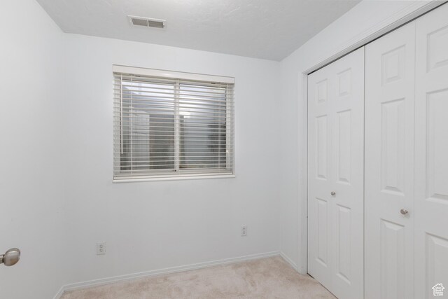 1199 E Pheasant View Dr, Layton, UT 84041 - unfurnished bedroom with light carpet, a closet, and baseboards