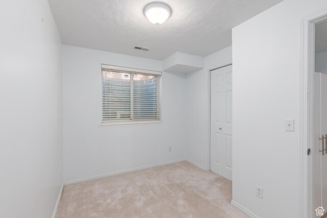 1199 E Pheasant View Dr, Layton, UT 84041 - unfurnished bedroom featuring light carpet, a textured ceiling, baseboards, and a closet