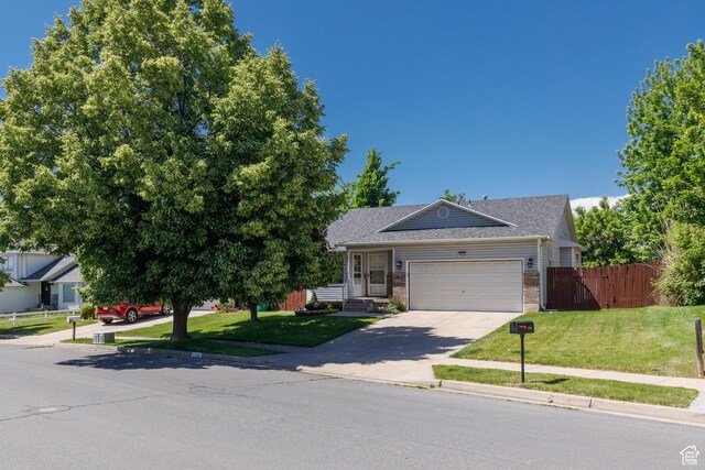 1199 E Pheasant View Dr, Layton, UT 84041 - view of front facade with brick siding, a garage, concrete driveway, and roof with shingles