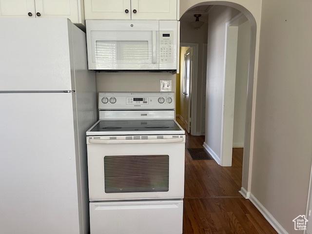 2646 S 1700 E, Salt Lake City, UT 84106 - kitchen with white appliances, arched walkways, dark wood finished floors, baseboards, and white cabinetry