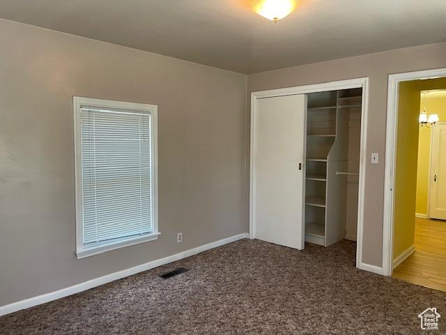 2646 S 1700 E, Salt Lake City, UT 84106 - unfurnished bedroom with a closet, carpet, a chandelier, and baseboards