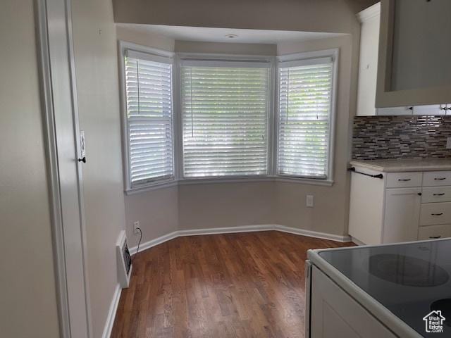 2646 S 1700 E, Salt Lake City, UT 84106 - kitchen featuring electric stove, white cabinetry, wood finished floors, baseboards, and plenty of natural light