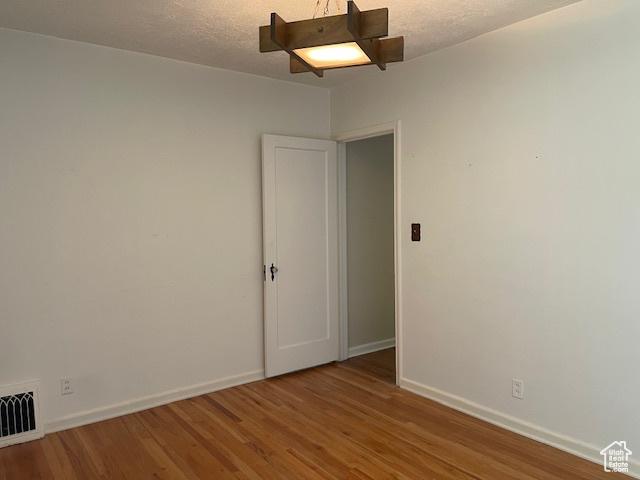 2646 S 1700 E, Salt Lake City, UT 84106 - unfurnished room featuring baseboards, wood finished floors, and a textured ceiling