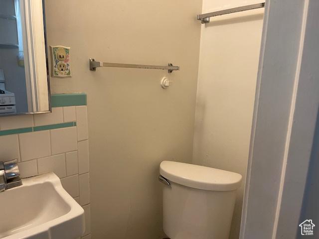 2646 S 1700 E, Salt Lake City, UT 84106 - bathroom with a sink, toilet, and decorative backsplash