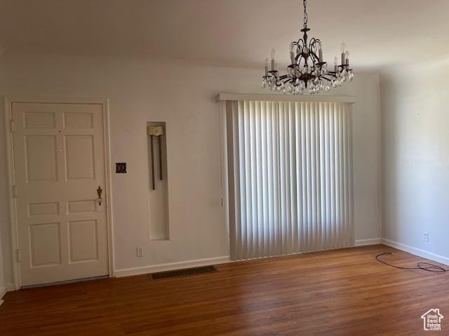 2646 S 1700 E, Salt Lake City, UT 84106 - unfurnished room featuring wood finished floors, baseboards, and a chandelier