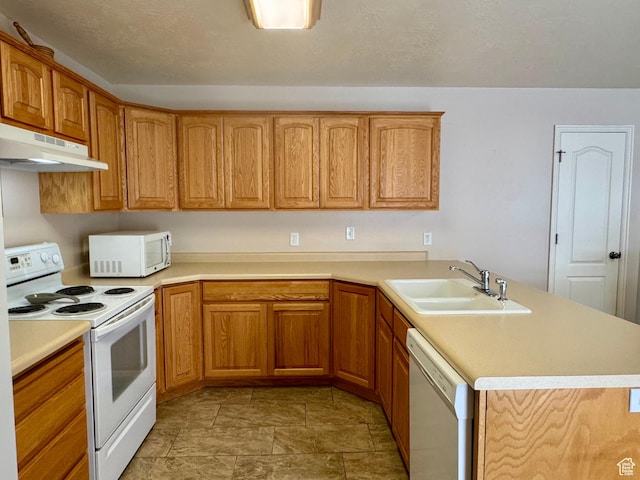 445 Topaz Blvd Unit 10, Delta, UT 84624 - kitchen with white appliances, a sink, under cabinet range hood, a peninsula, and light countertops