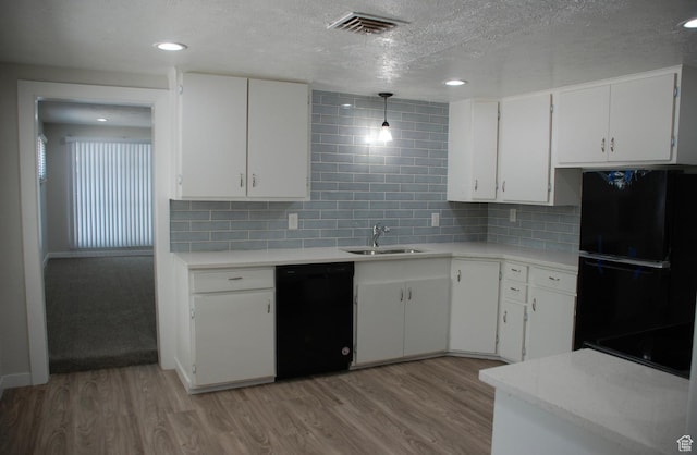 1530 N 2000 W, Farr West, UT 84404 - kitchen featuring black appliances, light countertops, light wood finished floors, a sink, and a textured ceiling