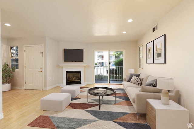3760 S Carlisle Park Pl Unit 1, Salt Lake City, UT 84119 - living area featuring recessed lighting, light wood-type flooring, a glass covered fireplace, and baseboards