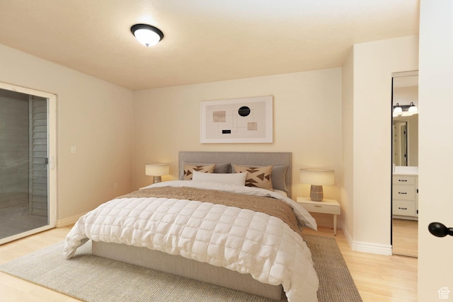3760 S Carlisle Park Pl Unit 1, Salt Lake City, UT 84119 - bedroom with light wood finished floors, baseboards, and access to outside