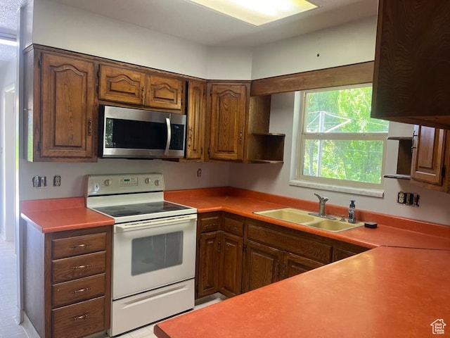 160 E 300 S, Gunnison, UT 84634 - kitchen featuring stainless steel microwave, electric range, open shelves, and light countertops
