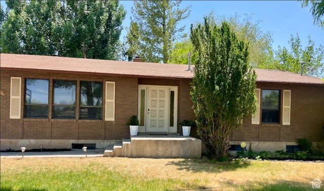 160 E 300 S, Gunnison, UT 84634 - ranch-style house featuring a front yard and a chimney