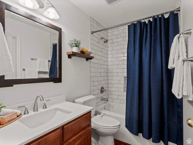 9750 S David St E, Sandy, UT 84070 - bathroom featuring vanity, toilet, and shower / bath combination with curtain
