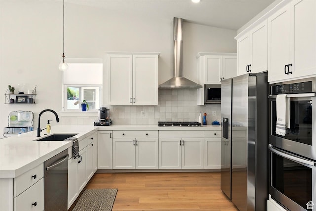 1335 S 1140 E, Heber City, UT 84032 - kitchen with stainless steel appliances, wall chimney exhaust hood, a sink, a peninsula, and tasteful backsplash