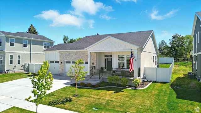 1335 S 1140 E, Heber City, UT 84032 - view of front of home featuring a porch, driveway, a garage, stone siding, and central AC