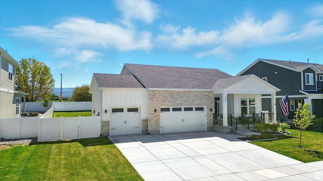 1335 S 1140 E, Heber City, UT 84032 - view of front of property featuring a garage, stone siding, board and batten siding, driveway, and roof with shingles