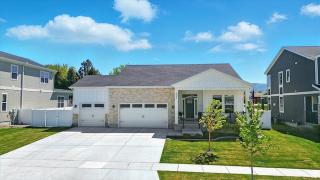 1335 S 1140 E, Heber City, UT 84032 - view of front of house with a garage, stone siding, board and batten siding, concrete driveway, and covered porch