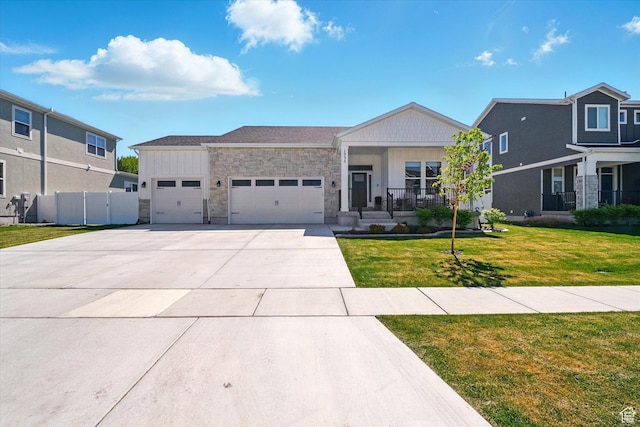 1335 S 1140 E, Heber City, UT 84032 - view of front facade featuring a garage, stone siding, driveway, and covered porch