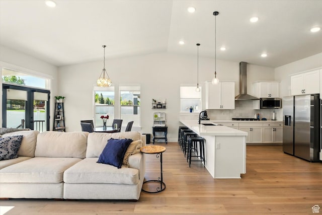 1335 S 1140 E, Heber City, UT 84032 - kitchen with stainless steel appliances, wall chimney range hood, open floor plan, a kitchen breakfast bar, and a sink