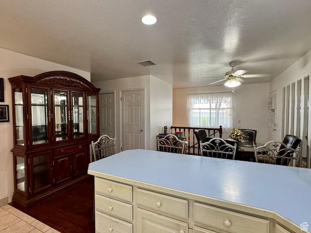 786 E Bristlecone Dr, Delta, UT 84624 - kitchen with ceiling fan, tile patterned flooring, light countertops, a textured ceiling, and cream cabinetry