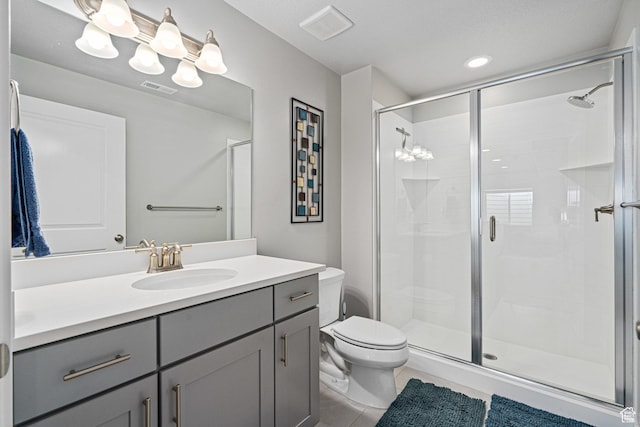 9857 N Featherstone Dr, Highland, UT 84003 - bathroom featuring toilet, vanity, a shower stall, tile patterned flooring, and recessed lighting