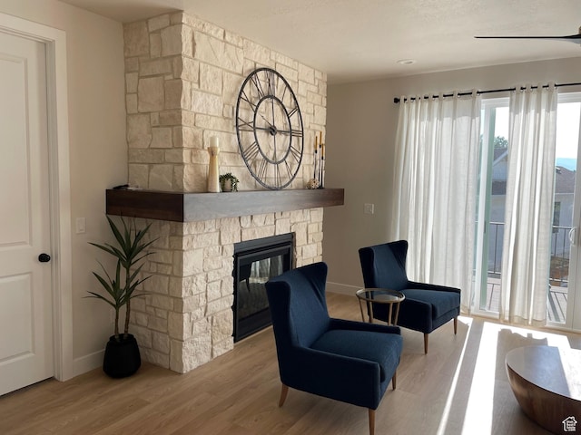 858 N Pinehurst Dr, Midway, UT 84049 - living room with wood finished floors, a stone fireplace, and baseboards