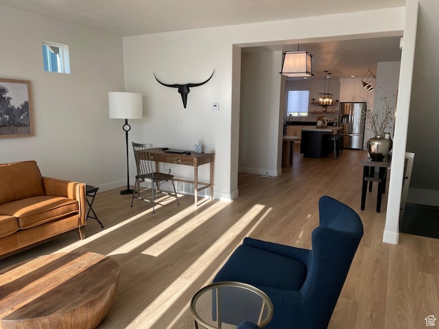 858 N Pinehurst Dr, Midway, UT 84049 - living area with light wood-type flooring, a chandelier, baseboards, and plenty of natural light