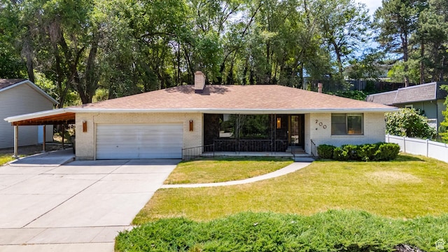 700 E Spruce Glen Rd, Murray, UT 84107 - single story home featuring brick siding, driveway, a chimney, an attached garage, and a porch
