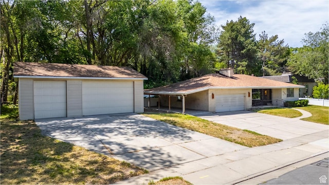 700 E Spruce Glen Rd, Murray, UT 84107 - single story home with a chimney, a detached garage, an outdoor structure, brick siding, and a front yard