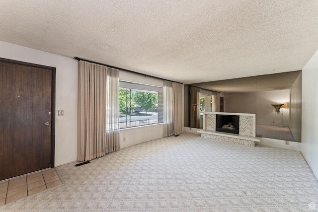 700 E Spruce Glen Rd, Murray, UT 84107 - unfurnished living room featuring carpet flooring, a fireplace with raised hearth, and a textured ceiling