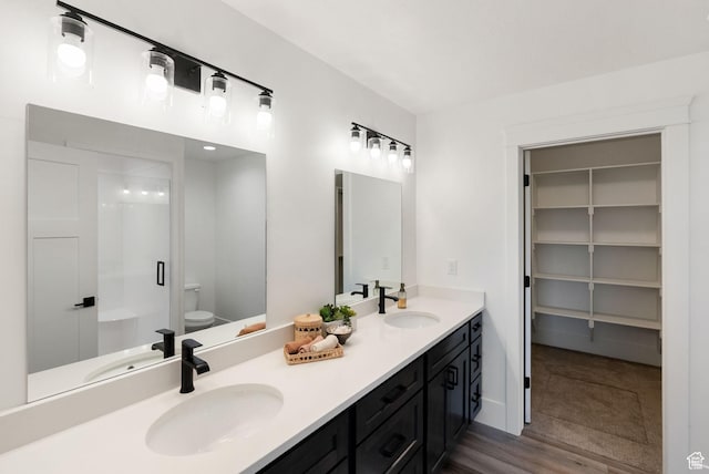 1120 S 800 W, Lewiston, UT 84320 - bathroom featuring toilet, double vanity, an enclosed shower, and wood finished floors