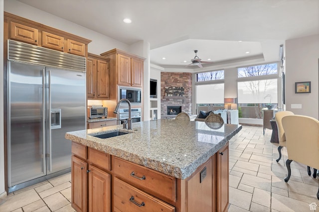 3052 N Snow Canyon Pwky Unit 168, St George, UT 84770 - kitchen featuring built in appliances, a sink, a ceiling fan, a center island with sink, and recessed lighting