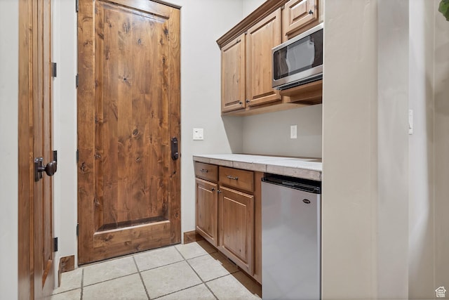 3052 N Snow Canyon Pwky Unit 168, St George, UT 84770 - kitchen featuring appliances with stainless steel finishes, light countertops, and light tile patterned floors