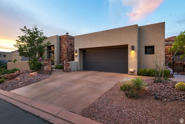 3052 N Snow Canyon Pwky Unit 168, St George, UT 84770 - pueblo-style home featuring a gate, a garage, and stucco siding