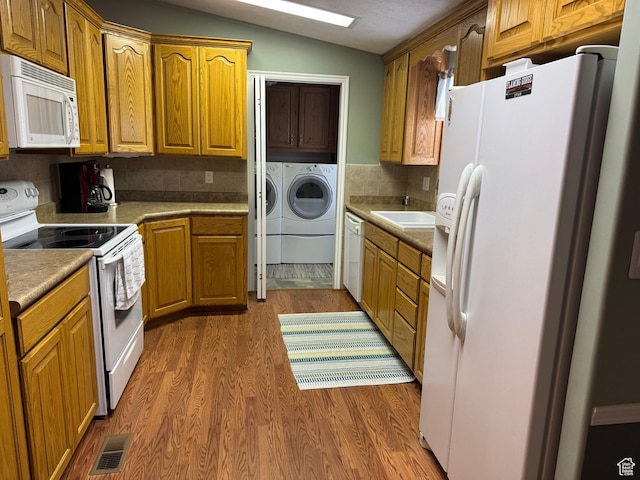 235 N 5th E, Manila, UT 84046 - kitchen featuring white appliances, washing machine and clothes dryer, wood finished floors, lofted ceiling, and brown cabinets