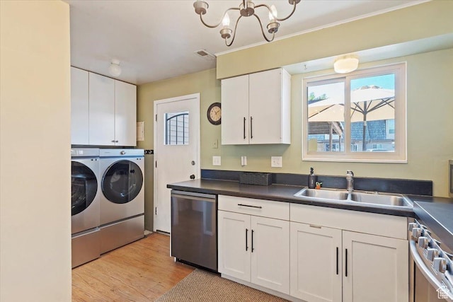 88 W 50 S Unit H7, Centerville, UT 84014 - kitchen with appliances with stainless steel finishes, washing machine and clothes dryer, white cabinetry, and a chandelier