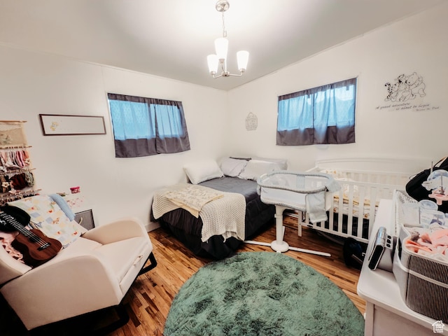 1 S 3rd Ave, Helper, UT 84526 - bedroom featuring multiple windows, wood finished floors, and a chandelier
