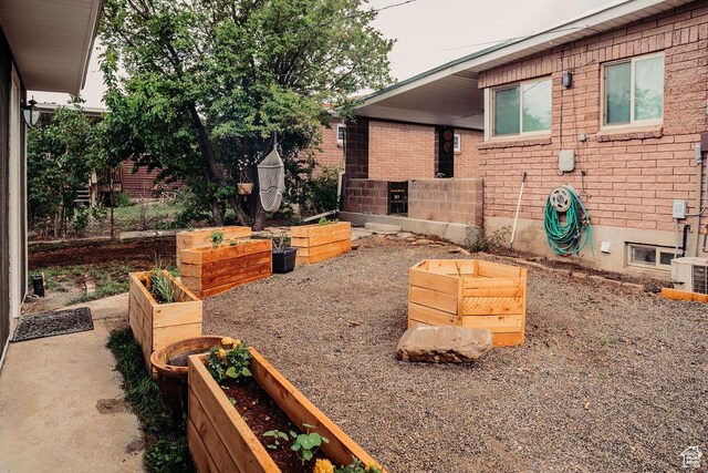 1 S 3rd Ave, Helper, UT 84526 - view of patio / terrace featuring a garden and central AC unit