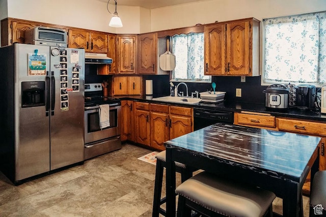 1 S 3rd Ave, Helper, UT 84526 - kitchen featuring stainless steel appliances, a sink, under cabinet range hood, and brown cabinets