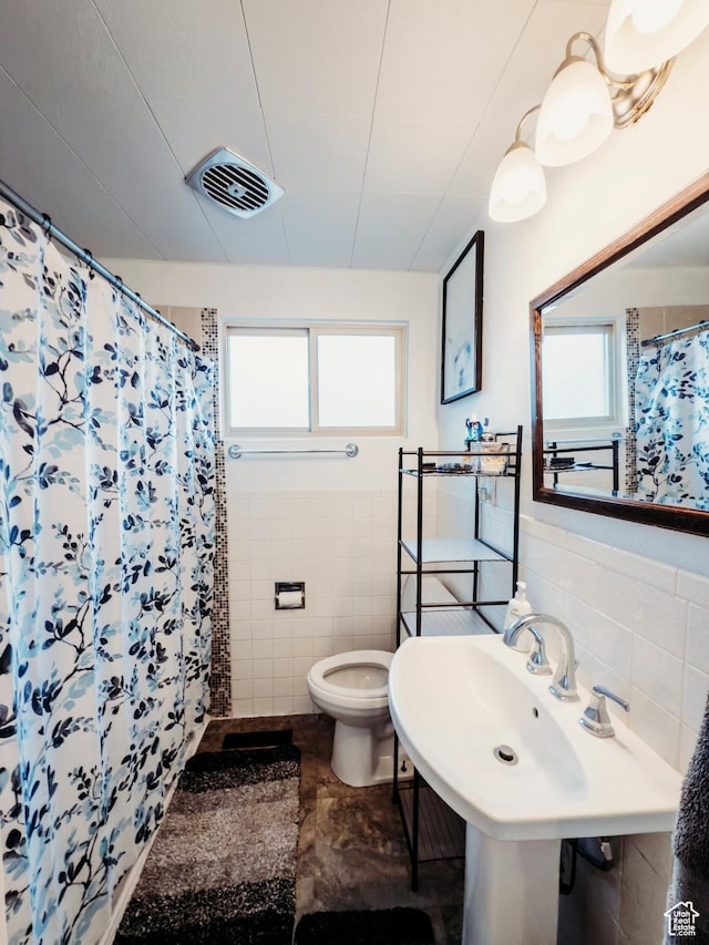 1 S 3rd Ave, Helper, UT 84526 - bathroom featuring tile walls, toilet, and a shower with shower curtain