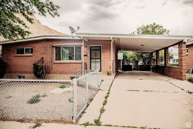 1 S 3rd Ave, Helper, UT 84526 - view of front of home with driveway, a carport, a gate, and brick siding